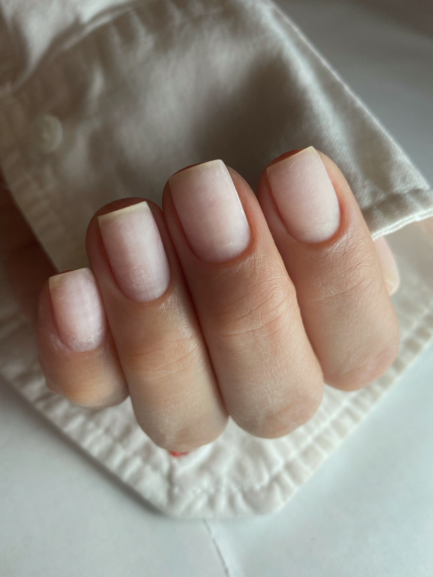 Clean natural nails after a Russian manicure — precise cuticle work and refined shaping